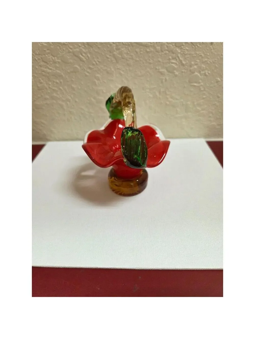 Vintage hand blown art Glass basket. Red, tan and green in color.